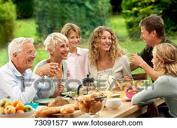 Picture - three generational 
family with children 
(9-10 years) having 
meal. fotosearch 
- search stock 
photos, pictures, 
images, and photo 
clipart