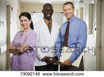 Stock Photo - three medical 
professionals 
standing in hospital 
corridor, portrait. 
fotosearch - search 
stock photos, 
pictures, images, 
and photo clipart