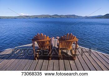 Stock Image - 'two adirondack 
chairs on a deck 
overlooking lake 
george, ny'. fotosearch 
- search stock 
photos, pictures, 
images, and photo 
clipart