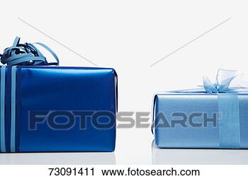 Stock Photography - two blue gifts 
side by side, 
studio shot. fotosearch 
- search stock 
photos, pictures, 
images, and photo 
clipart