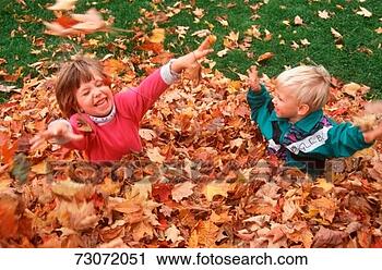 Stock Photography - 'two children 
playing in autumn 
leaves, sutton, 
vermont'. fotosearch 
- search stock 
photos, pictures, 
images, and photo 
clipart