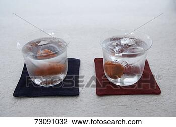 Stock Photo - two glasses of 
syochu with ice. 
fotosearch - search 
stock photos, 
pictures, images, 
and photo clipart
