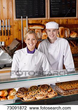 Stock Photo - two sales clerks 
behind bakery 
counter, portrait. 
fotosearch - search 
stock photos, 
pictures, images, 
and photo clipart