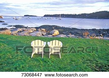 Picture - 'two wooden lawn 
chairs set near 
the shore with 
a view of the 
harbor. fotosearch 
- search stock 
photos, pictures, 
images, and photo 
clipart