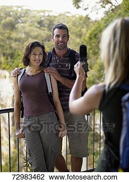Stock Photo - woman photographing 
couple at lookout. 
fotosearch - search 
stock photos, 
pictures, images, 
and photo clipart