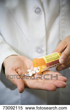 Stock Image - woman spilling 
tablets into palm, 
close-up of hand. 
fotosearch - search 
stock photos, 
pictures, images, 
and photo clipart