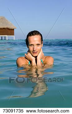 Stock Image - woman standing 
in water, maldives. 
fotosearch - search 
stock photos, 
pictures, images, 
and photo clipart