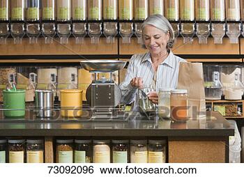 Stock Photo - woman weighing 
groceries on counter 
top. fotosearch 
- search stock 
photos, pictures, 
images, and photo 
clipart