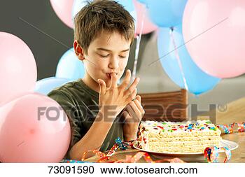 Stock Photography - young boy (10-11 
years) with birthday 
cake, licking 
fingers. fotosearch 
- search stock 
photos, pictures, 
images, and photo 
clipart