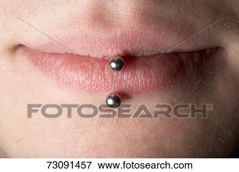 Picture - young man with 
piercing in lips, 
close-up. fotosearch 
- search stock 
photos, pictures, 
images, and photo 
clipart