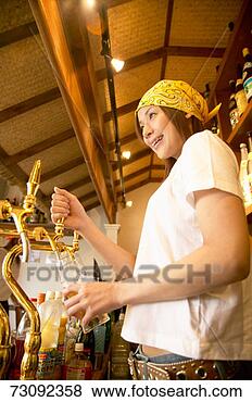 Stock Photo - young woman pulling 
a pint. fotosearch 
- search stock 
photos, pictures, 
images, and photo 
clipart