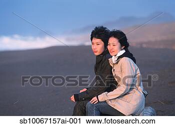 Stock Photography - young couple sitting 
on beach at dusk. 
fotosearch - search 
stock photos, 
pictures, images, 
and photo clipart