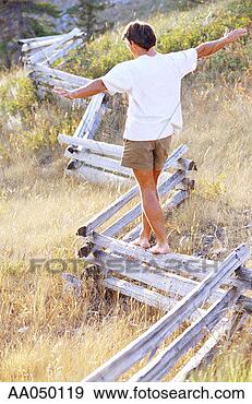 Stock Photograph - man walking on 
fence, arms outstretched. 
fotosearch - search 
stock photos, 
pictures, images, 
and photo clipart