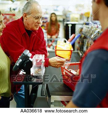 Stock Photo - mature couple 
using credit card 
at the supermarket. 
fotosearch - search 
stock photos, 
pictures, images, 
and photo clipart