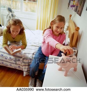 Stock Photography - young girl saves 
money in piggy 
bank. fotosearch 
- search stock 
photos, pictures, 
images, and photo 
clipart