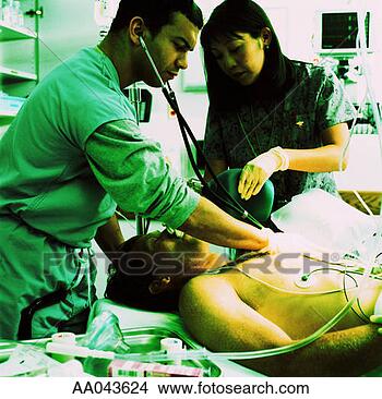 Stock Photo - emergency room 
doctor examining 
patient. fotosearch 
- search stock 
photos, pictures, 
images, and photo 
clipart