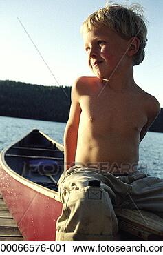 Stock Photography - boy (4-6) sitting 
in canoe on end 
of dock, portrait, 
low angle view. 
fotosearch - search 
stock photos, 
pictures, images, 
and photo clipart