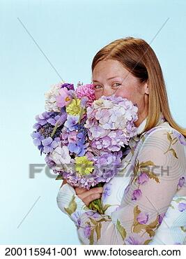Stock Photography - young woman smelling 
bouquet of flowers, 
portrait. fotosearch 
- search stock 
photos, pictures, 
images, and photo 
clipart