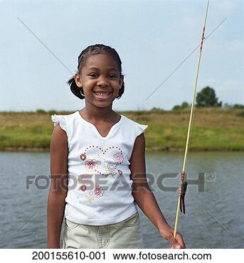 Stock Photography - girl (5-7) standing 
beside waterway 
holding fishing 
pole, portrait. 
fotosearch - search 
stock photos, 
pictures, images, 
and photo clipart