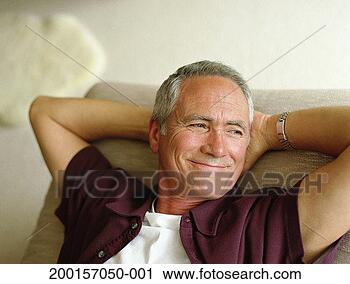 Stock Photography - mature man relaxing 
with hands behind 
head, smiling, 
close-up. fotosearch 
- search stock 
photos, pictures, 
images, and photo 
clipart