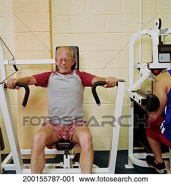 Stock Photography - mature man using 
gym equipment, 
eyes closed, grimacing. 
fotosearch - search 
stock photos, 
pictures, images, 
and photo clipart