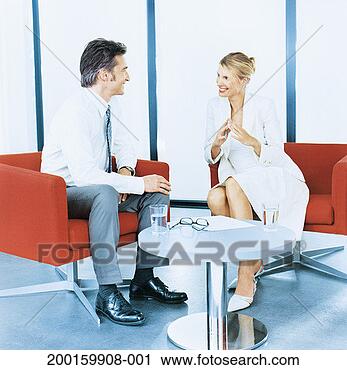 Stock Photography - two business colleagues 
sitting in armchairs 
in office. fotosearch 
- search stock 
photos, pictures, 
images, and photo 
clipart