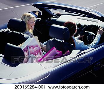 Stock Photography - two women in convertable, 
shopping bags 
in back seat, 
elevated view. 
fotosearch - search 
stock photos, 
pictures, images, 
and photo clipart