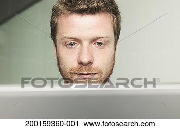 Stock Photography - young man looking 
at computer screen. 
fotosearch - search 
stock photos, 
pictures, images, 
and photo clipart