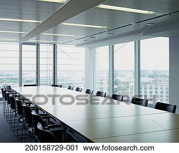 Stock Photography - boardroom table 
and chairs, by 
windows overlooking 
cityscape. fotosearch 
- search stock 
photos, pictures, 
images, and photo 
clipart