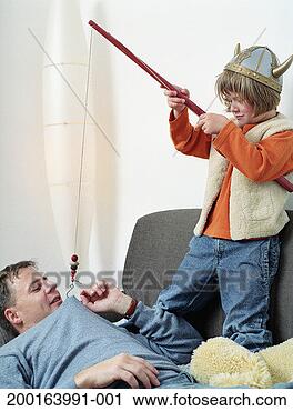 Stock Photography - boy (5-7) holding 
fishing rod, hook 
attached to father's 
jumper. fotosearch 
- search stock 
photos, pictures, 
images, and photo 
clipart