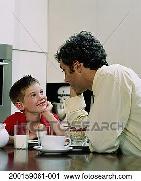 Stock Photography - father and son 
(6-8) looking 
at each other 
over breakfast 
table. fotosearch 
- search stock 
photos, pictures, 
images, and photo 
clipart