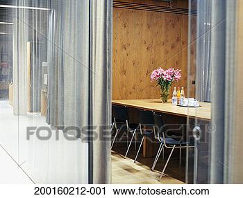 Stock Photography - flowers and soft 
drinks on conference 
table, view through 
open door. fotosearch 
- search stock 
photos, pictures, 
images, and photo 
clipart