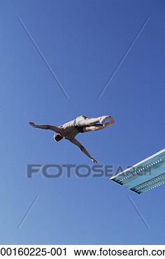 Stock Photography - male diver executing 
dive off of springboard, 
low angle view. 
fotosearch - search 
stock photos, 
pictures, images, 
and photo clipart