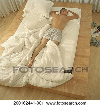 Stock Photography - man asleep in 
bed, rear view, 
elevated view. 
fotosearch - search 
stock photos, 
pictures, images, 
and photo clipart