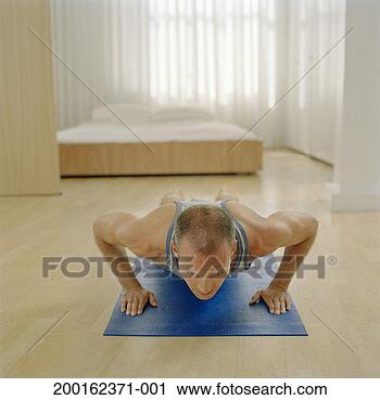 Stock Photography - man doing press-ups 
on exercise mat. 
fotosearch - search 
stock photos, 
pictures, images, 
and photo clipart