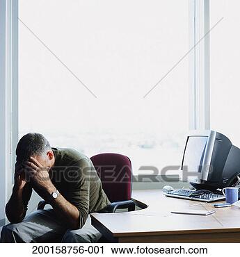Stock Photography - mature businessman 
at desk, resting 
head in hands. 
fotosearch - search 
stock photos, 
pictures, images, 
and photo clipart