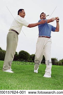 Stock Photography - mature man teachin 
man to swing golf 
club. fotosearch 
- search stock 
photos, pictures, 
images, and photo 
clipart