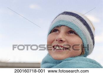 Stock Photography - teenage girl (12-14) 
wearing knit hat, 
looking up. fotosearch 
- search stock 
photos, pictures, 
images, and photo 
clipart