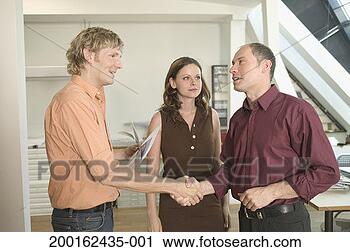 Stock Photography - three business 
people in office, 
men shaking hands. 
fotosearch - search 
stock photos, 
pictures, images, 
and photo clipart