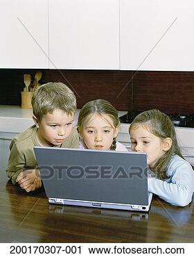 Stock Photography - three children 
(4-6) at kitchen 
table using laptop 
computer. fotosearch 
- search stock 
photos, pictures, 
images, and photo 
clipart