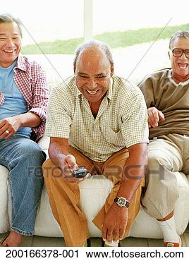 Stock Photography - three men on sofa, 
senior man holding 
remote control 
sitting forward. 
fotosearch - search 
stock photos, 
pictures, images, 
and photo clipart