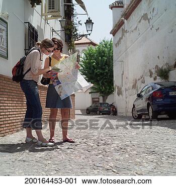 Stock Photography - two female tourists 
on cobbled street 
looking at map. 
fotosearch - search 
stock photos, 
pictures, images, 
and photo clipart