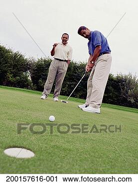 Stock Photography - two mature men 
golfing, one man 
putting. fotosearch 
- search stock 
photos, pictures, 
images, and photo 
clipart