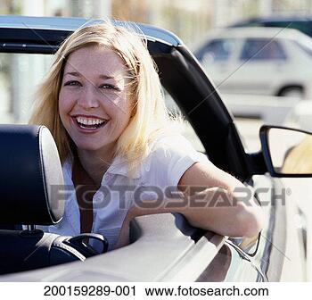 Stock Photography - woman in convertable 
car, smiling, 
portrait. fotosearch 
- search stock 
photos, pictures, 
images, and photo 
clipart