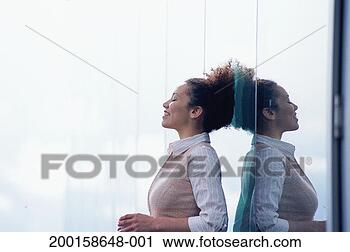 Stock Photography - woman leaning 
against glass 
wall, eyes closed, 
side view. fotosearch 
- search stock 
photos, pictures, 
images, and photo 
clipart