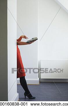 Stock Photography - woman using calculator, 
upper body obscured 
behind wall. fotosearch 
- search stock 
photos, pictures, 
images, and photo 
clipart