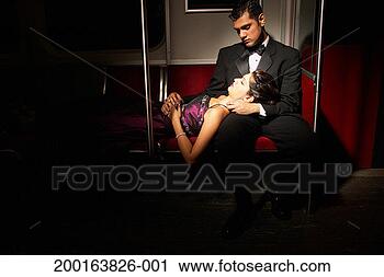 Stock Photography - young couple in 
formalwear on 
subway, woman 
resting head on 
man's lap. fotosearch 
- search stock 
photos, pictures, 
images, and photo 
clipart
