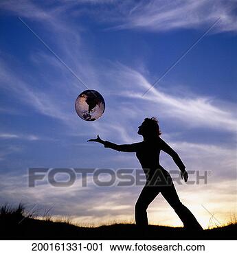 Stock Photography - young woman outdoors 
at sunset with 
inflatable globe, 
silhouette. fotosearch 
- search stock 
photos, pictures, 
images, and photo 
clipart
