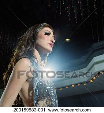 Stock Photography - young woman wearing 
sparkly shirt, 
low angle view. 
fotosearch - search 
stock photos, 
pictures, images, 
and photo clipart