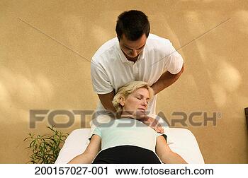 Stock Photography - young man massaging 
back of mature 
woman's head. 
fotosearch - search 
stock photos, 
pictures, images, 
and photo clipart